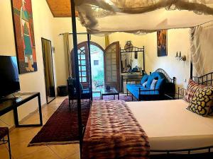 1 dormitorio con 1 cama y sala de estar en Villa Charles - île de Gorée en Gorée