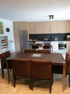 a kitchen with a dining room table and chairs at Casa d'Amêndoa in Felgar