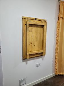 a wooden cabinet on a wall in a room at Departamento Desire in Puerto Deseado