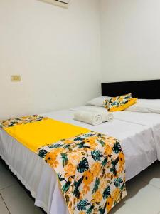 Säng eller sängar i ett rum på Hotel Villa Real Tolú