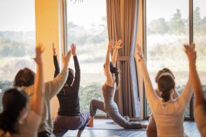 a group of women doing yoga in front of a window at Chuidasun Resort Tea & Meditation in Seogwipo +56 photos
