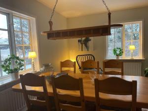 una sala da pranzo con tavolo e sedie in legno di Holiday home JÄRNA II a Järna