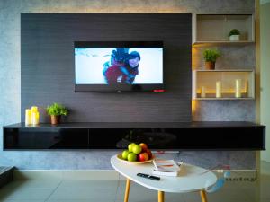 a living room with a flat screen tv on a wall at Bali Residence Seaview I 2BR I 8-10pax I Waterpark I JonkerSt in Melaka