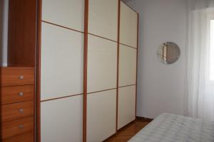 a bedroom with a large white cabinet and a bed at Frugol nest in Como