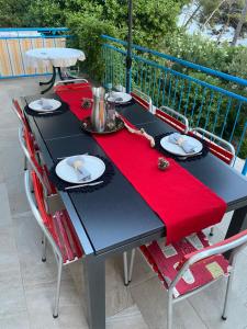 a black table with a red napkin on it at Casa Liliana By the Sea in Mali Lošinj