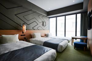a hotel room with two beds and a window at Asakusa View Hotel Annex Rokku in Tokyo +86 photos