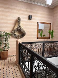 a balcony with a mirror and plants on the wall at Riad Black Doors in Marrakesh