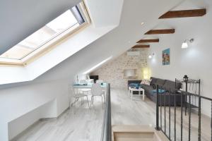 a loft conversion with a staircase and a living room at House Riva in Supetar