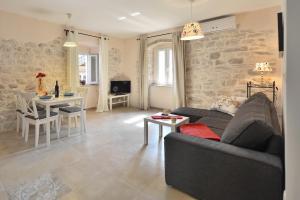 a living room with a couch and a table at House Riva in Supetar