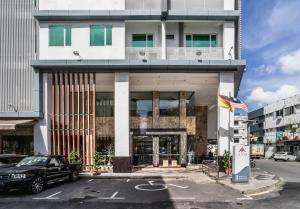 a black car parked in front of a building at Ano Hotel in Miri