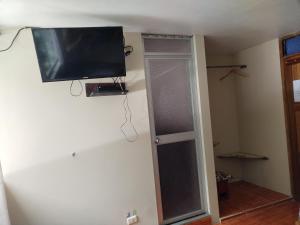 a room with a flat screen tv on the wall at ECO ART Best view Machu Picchu in Machu Picchu