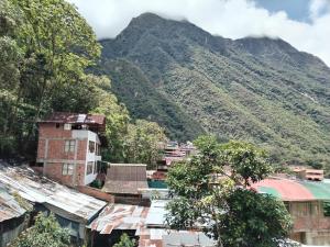 a village with a mountain in the background at ECO ART Best view Machu Picchu in Machu Picchu