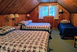 a bedroom with two beds and a window at Cabin #5 in Strawberry