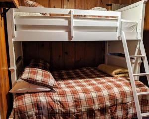 a white bunk bed with a checkered bedsheet at Cabin #7 in Strawberry +1 photo