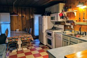 a kitchen with a refrigerator and a stove top oven at Cabin #7 in Strawberry