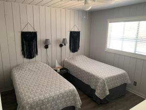 a bedroom with two beds and a window at Cabin #6 in Strawberry