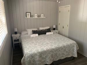 a bedroom with a bed with two tables and two lamps at Cabin #6 in Strawberry