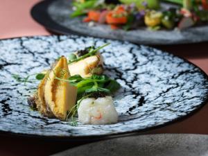 a plate of food with sushi on a table at Lake Toya Tsuruga Resort HIKARINOUTA in Lake Toya