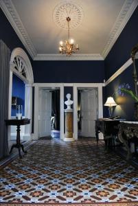 a room with blue walls and a chandelier at Flemings Country House in Cork