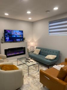 a living room with a couch and a tv at A very nice Basement ensuite. in Calgary