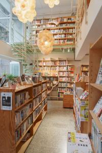 a library with many shelves of books at OwlStay Flip Flop Hostel - Garden in Taipei