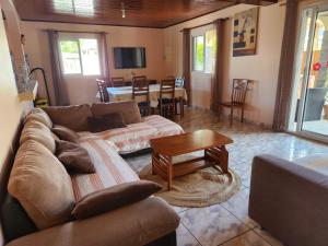a living room with a couch and a table at CASAMELIAS "La glycine" in Cilaos