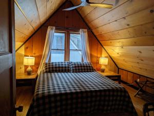 a bedroom with a bed and a window in a cabin at Cabin #8 in Strawberry