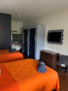 a hotel room with two beds and a flat screen tv at Orange County National Golf Center and Lodge in Orlando