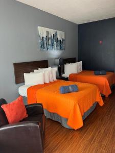a hotel room with two beds and a couch at Orange County National Golf Center and Lodge in Orlando