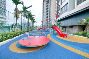 a playground with a red slide on a blue carpet at NEW Stylish Seaview Bali Residences studio near Jonker 4 pax in Melaka