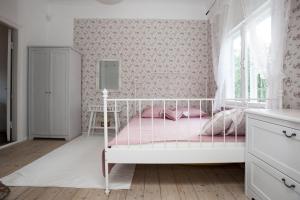 a pink bedroom with a white bed with pink sheets at Pärnu Summer Home in Pärnu