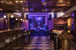 a bar with chairs and a stage in a room at The Park Kolkata in Kolkata