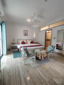 a bedroom with a bed and two chairs in it at Girisadan Boutique Hotel in Jaipur