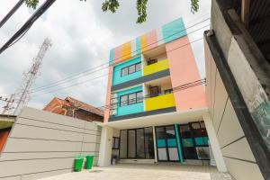 a building with a colorful facade at Sans Hotel Clover Ace Surabaya by RedDoorz in Surabaya