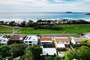 an aerial view of a house and the ocean at Surfs Up! Oceanfront Home Sleeps 6 steps from the sand in Emerald Beach