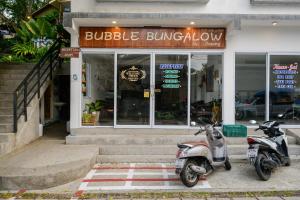 two motorcycles parked in front of a building at Bubble Bungalow in Ko Tao