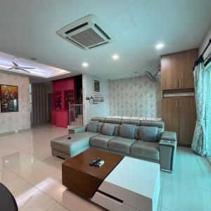 a living room with a couch and a table at Countryside Homestay in Sekincan