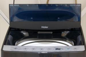 a microwave sitting on top of a washing machine at SAPPHIRE -SEVEN Hotels and Resorts- in Okinawa City