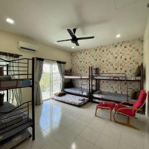 a room with bunk beds and a ceiling fan at Countryside Homestay in Sekincan