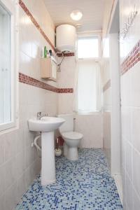 a bathroom with a sink and a toilet at Pärnu Summer Home in Pärnu +17 photos