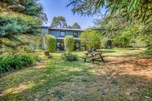 a house with a picnic table in the yard at Cedar Cottage Unit 5 in Bright