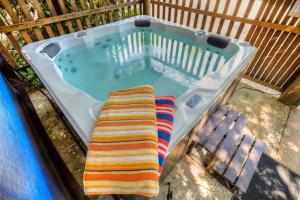 a bath tub with a striped towel in it at Cedar Cottage Unit 5 in Bright