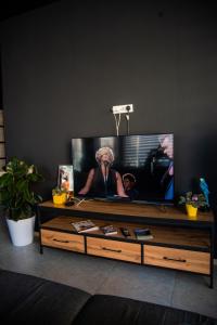 a flat screen tv sitting in a living room at Safarov's Family Hostel in Tashkent