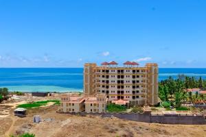 a building under construction with the ocean in the background at Sunrise Resort Apartments and SPA - Nyali, Mombasa, Kenya in Mombasa +107 photos