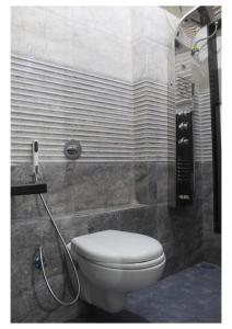 a bathroom with a toilet and a shower at Passion Homes in Mumbai