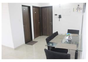 a room with a table and chairs and a wooden door at Passion Homes in Mumbai