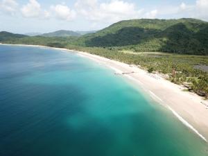 an aerial view of a beach and the ocean at Nacpan Beach Glamping Managed by H Hospitality Group in El Nido