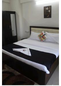 a bedroom with a bed with a black and white blanket at Artist Alley Apartments in Mumbai