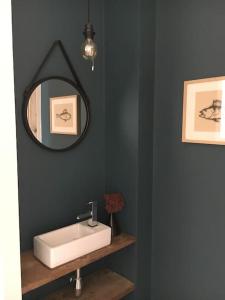 een badkamer met een witte wastafel en een spiegel bij Villa neuve et moderne avec piscine à Grimaud in Grimaud