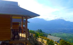 a house with a balcony with a view of mountains at CHEENI HILL RESORTS in Kanthalloor